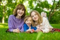 Two big sisters and their toddler brother having fun in city park on warm spring day. Children having a picnic outdoors. Three Royalty Free Stock Photo