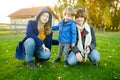 Two big sisters and their toddler brother having fun outdoors. Two young girls with a toddler boy on autumn day. Children with Royalty Free Stock Photo