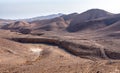 Two bikers on a mountain bike trail from city Arad to the Dead Sea, Judaean Desert, Israel.