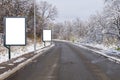 Two billboards on country asphalt road with tree covered with snow an sky nature background Royalty Free Stock Photo