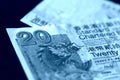 Two bills of twenty Hong Kong dollars on a dark background. Blue color toned Royalty Free Stock Photo