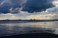 Two birds flying low over the water near sunset under a dramatic ominous sky will rain falling on the distant mountains - Bribie I