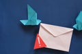 Two birds paper origami carrying letter envelope with warning sign. Phishing email scam and fraudulent message.