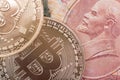 Two Bitcoin coins lie on top of Soviet paper money rubles with the symbol of the USSR Lenin Royalty Free Stock Photo