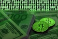 Two bitcoins lies on a pile of dollar bills on the background of a monitor depicting a binary code of bright green zeros and one u Royalty Free Stock Photo