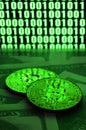 Two bitcoins lies on a pile of dollar bills on the background of a monitor depicting a binary code of bright green zeros and one u Royalty Free Stock Photo