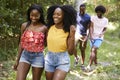 Two black adult couples talking during a walk in a forest