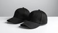 Two Black Baseball Caps on White Surface Royalty Free Stock Photo