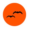 Two black bats on an orange circle, round icon, flat style, simple color change. Royalty Free Stock Photo