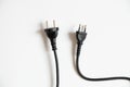 Two black cables with plugs on a white background, cable Royalty Free Stock Photo