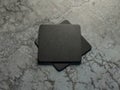 Two Black cardboard beer coasters Mockup on the concrete floor