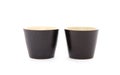 Two black coarse porcelain tea cups on white background Royalty Free Stock Photo