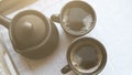 Two black coffee cups and clay ibrik on the wooden salver