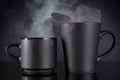Two black coffee cups with steam Royalty Free Stock Photo