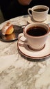 Two black coffees with snacks next to them on the table Royalty Free Stock Photo