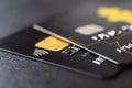 Two black debit cards for cash withdrawals and money transfers. Credit cards with chip and contactless technology macro. Bank