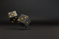 Two black dice with gold dots floating with copy space. 3d illustration Royalty Free Stock Photo