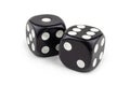 Two black dice isolated on a white background. The result is one and six with a slight shadow. Macro photo. Royalty Free Stock Photo