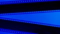 Two black film strips on blue background close up. 35mm film slide frame. Copy space.
