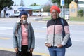 Two black masked ladies on the street