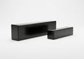Two black rectangular objects with a smooth and shiny surface on a white background Royalty Free Stock Photo
