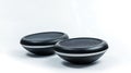 Two black round objects on a white background Royalty Free Stock Photo