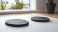 Two black round objects on a white table Royalty Free Stock Photo