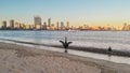 Two Black Swans on the shoreline of Swan River in Perth, Western Australia. Perth city skyline with its modern Royalty Free Stock Photo