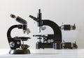 Two black vintage microscopes, side view Royalty Free Stock Photo