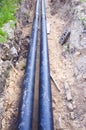 Two black waterpipes in a ditch Royalty Free Stock Photo