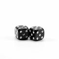 Two black and white dice with the number five on all sides, close-up on a white background, unusual lot Royalty Free Stock Photo