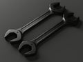 Two black wrenches on a gray surface Royalty Free Stock Photo