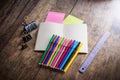 two blank colorful sticky notes , notebook ,pencil ,highlighter, clip, Magic Colors, ruler