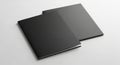 Two blank dark grey closed brochures or booklets stacked on a clean white surface Royalty Free Stock Photo