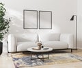 Two blank frame mock up on white wall in room with white sofa and decoration, 3d rendering. Royalty Free Stock Photo