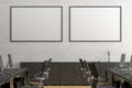 Two blank horizontal posters mock up on the white brick wall in office interior. Royalty Free Stock Photo