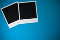 Two blank instant photo frames on blue background with copy space top view Royalty Free Stock Photo