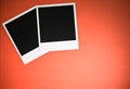 Two blank instant photo frames on red background with copy space top view Royalty Free Stock Photo