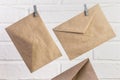 Two blank kraft paper envelopes hanging, communication concept in retro style, postal background Royalty Free Stock Photo