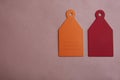 Two blank label mockup on pink background. Plain empty name tag mock up with red and orange label. Top view Royalty Free Stock Photo