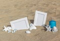 Two blank photo frames on the sand beach with decoration Royalty Free Stock Photo