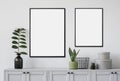Two blank picture frames mockup on gray wall. Templates for painting or poster. White living room interior design. Royalty Free Stock Photo