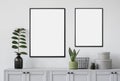 Two blank picture frames mockup on gray wall. Templates for painting or poster. White living room interior design.