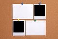 Two blank polaroid style photo prints with index cards on cork notice board, copy space Royalty Free Stock Photo