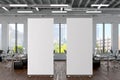 Two blank roll up banner stands in white brick office interior. Royalty Free Stock Photo