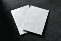 Two blank sheets of paper on dark surface Royalty Free Stock Photo