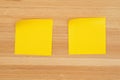 Two blank sticky notes on textured desk wood background Royalty Free Stock Photo