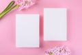 Two Blank wedding invitation stationery card mockup on pink background with hyacinth flowers, 5x7 Royalty Free Stock Photo