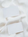 Two blank white cards on clean white textile background top view Royalty Free Stock Photo