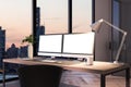 Two blank white computer screens on office desktop in interior with night city view. Corporate template. Mock up Royalty Free Stock Photo